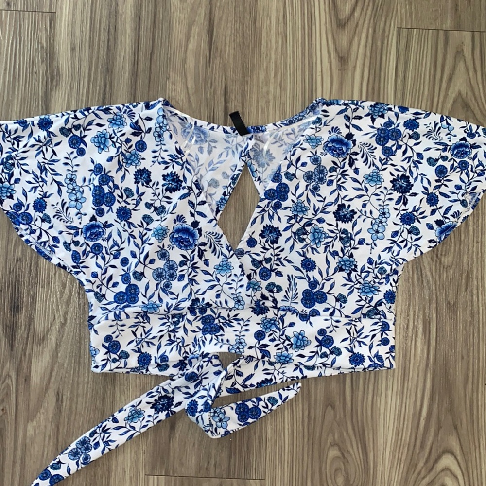white and blue flower patterned wrap top